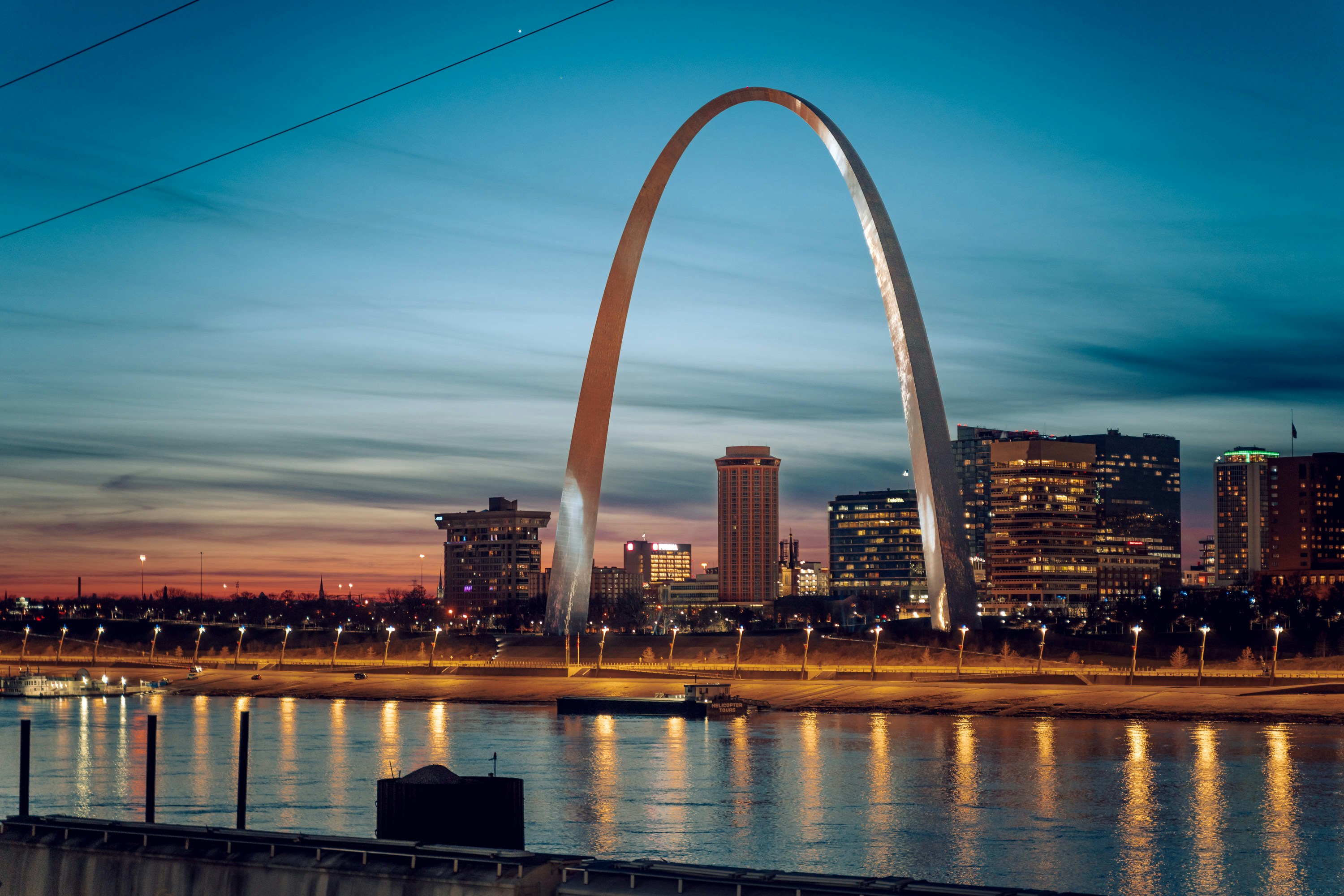The Gateway Arch at dusk over the Mississippi River
